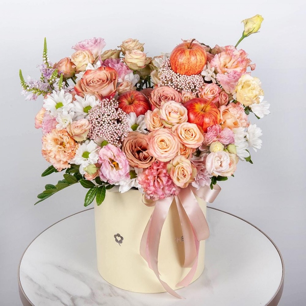 Bacardi White Spray Chrysanthemum - 2, Spray rose: white, cream, light pink 50 cm - 5, Роза Тоффи - 5, Pink Lisianthus (Eustoma) - 2, Round flower box medium, Oasis, Veronica spray, Ozotamnus, Pistachio,  Raspberry branch, Apple, 1 pc., Ribbon
