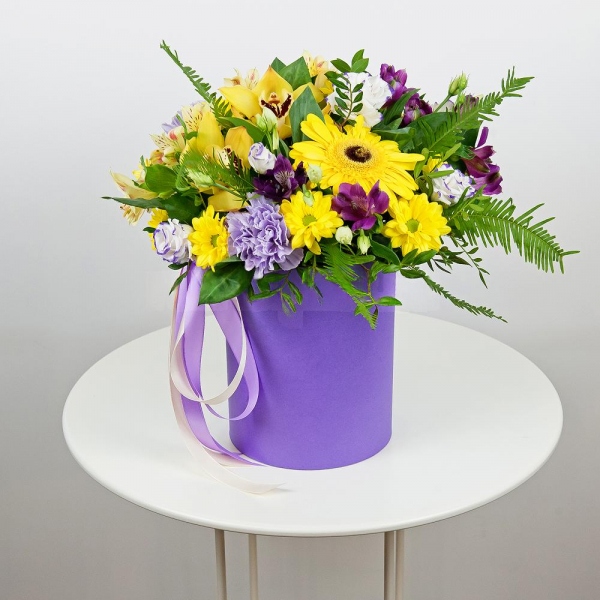 Gerbera yellow - 3, Lilac carnation - 3, Orchid bud yellow/brown Cymbidium - 3, Alstromeria Yellow, Orange - 1, Purple Lisianthus (Eustoma) - 6, Bacardi Yellow Spray Chrysanthemum - 4, Alstromeria lilac, purple - 2, Round flower box small , Film, Oasis, Pistachio, Ruscus, Ambrella, Ribbon, Flask for orchids