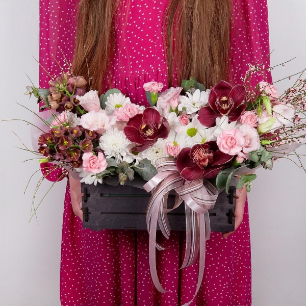Pink Cymbidium Orchid Bud - 3, Baltica White Spray Chrysanthemum - 1, Pink Lisianthus (Eustoma) - 3, Pink spray carnation - 3, White Delphinium - 2, Bacardi White Spray Chrysanthemum - 1, Wooden pot, Oasis, Wrapping Paper, Flask for orchids, Eucalyptus, Genista