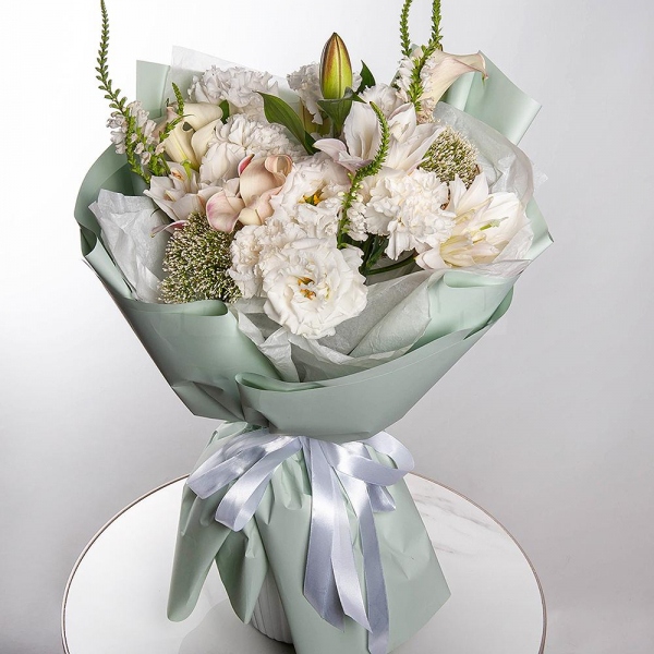 Lilies - 2, Calla lilies - 3, Carnation white, cream - 11, lisianthus - 3, Veronica spray, Sedum, Wrapping Paper