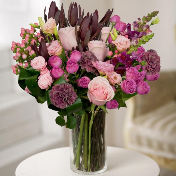 Pink Lisianthus (Eustoma) - 2, Matthiola Lilac - 3, Bright pink spray rose mix, 50 cm - 4, Pink rose 50 cm - 4, Lilac carnation - 4, Leukodendron, Hypericum, Aspidistra (1 pc.), Wrapping Paper