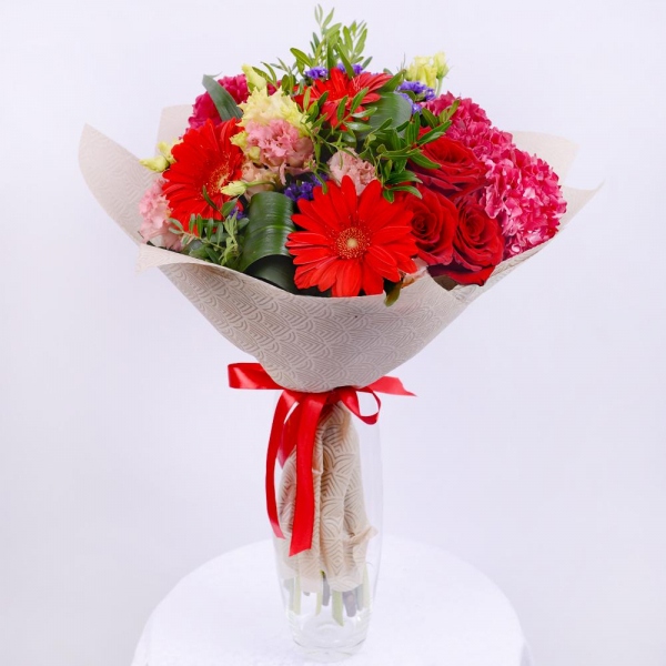 Pink Hydrangea - 3, lisianthus - 7, Gerbera red - 5, Red rose 50 cm - 7, Aspidistra (1 pc.), Blue Statice, Pistachio, Felt, Ribbon