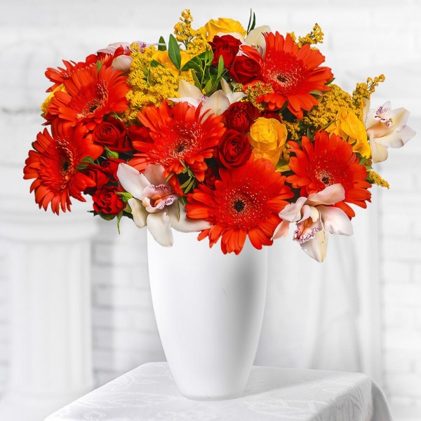 Gerbera daisies - 11, White Cymbidium Orchid Bud - 11, Spray rose: red 50 cm - 10, Yellow rose 50 cm - 7, Flask for orchids, Solidago (1 pc.), Pistachio, Mesh (Abaka), Ribbon