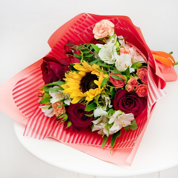 Sunflower - 1, Alstromeria white, soft pink - 4, Spray rose: red 50 cm - 3, Pink spray carnation - 2, Red rose 50 cm - 4, Spray rose: yellow, orange 50 cm - 2, Pistachio, Wrapping Paper