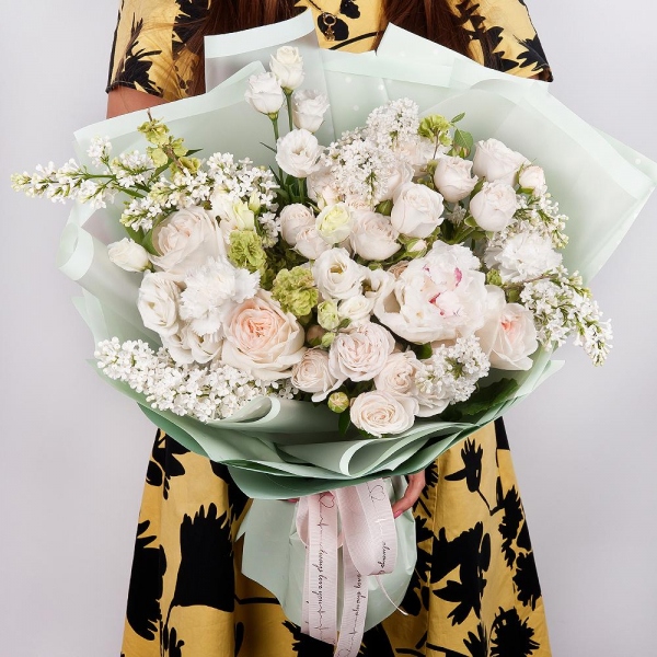 Peony white - 3, Peony style roses - 5, Peony sprayrose - 8, lisianthus - 5, Carnation white, cream - 5, White Lilac - 5, Wrapping Paper, Ribbon