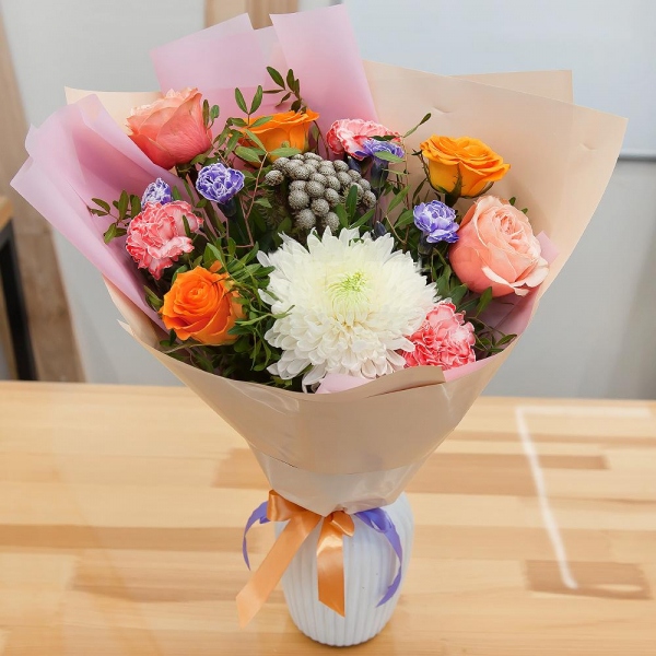 Magnum White Chrysanthemum - 1, Orange carnation - 5, Pink spray carnation - 3, Peony rose Kahala 50 cm - 3, Multicolor rose 50 cm - 4, Brunia Green Lanuginosa (1 pc.), Pistachio, Wrapping Paper, Ribbon