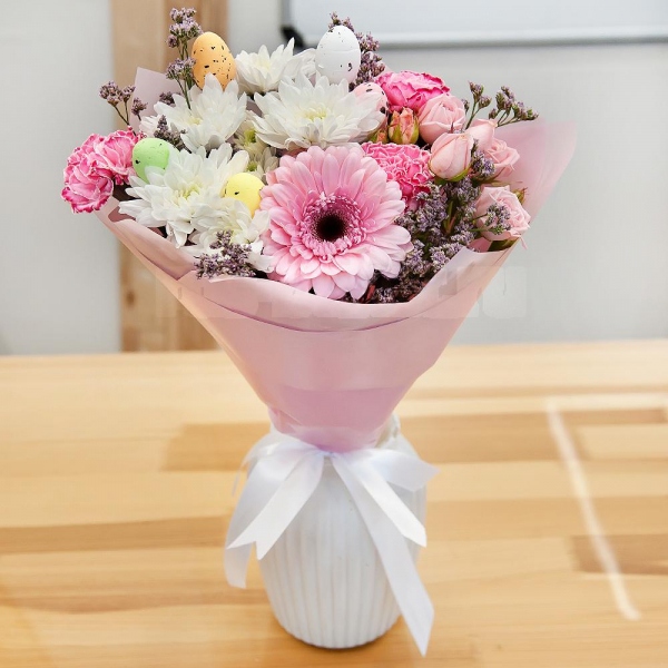 Bright pink spray rose mix, 50 cm - 2, Baltica White Spray Chrysanthemum - 1, Gerbera pink - 1, Pink carnation - 4, Limonium (1 pc.), Easter eggs (3 pc.), Wrapping Paper, Ribbon