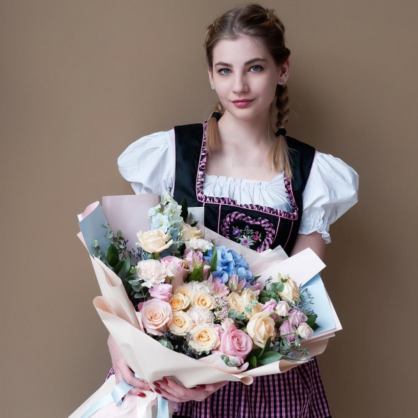 Blue/purple hydrangea - 1, Pink rose 50 cm - 5, Spray rose: white, cream, light pink 50 cm - 4, Rose Cream 50 cm - 6, Alstromeria white, soft pink - 5, Carnation white, cream - 9, Pink Lisianthus (Eustoma) - 3, Ozotamnus, Limonium (1 pc.), Blue Delphinium, Ruscus, Eucalyptus, Wrapping Paper